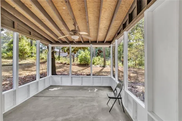 a room with large windows and furniture