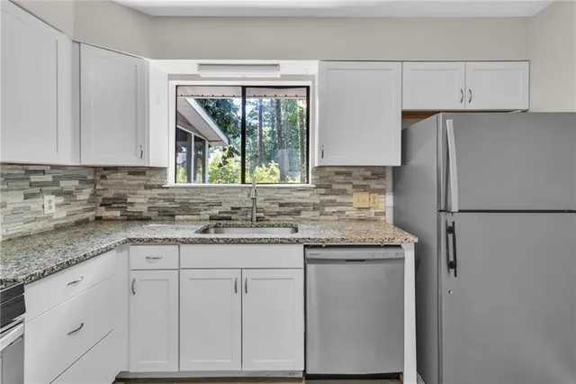 a kitchen with appliances cabinets and a sink