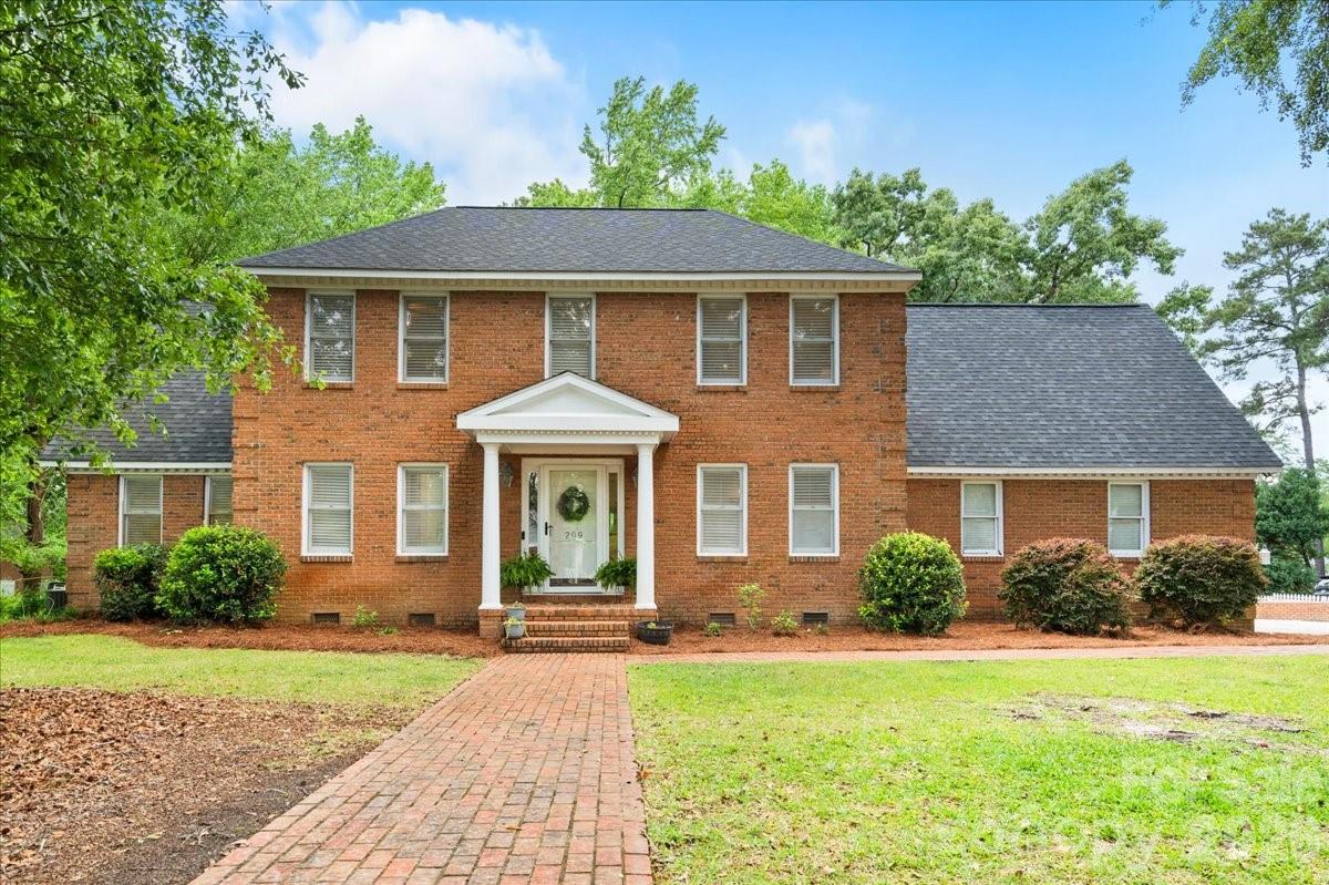 209 Fairway Road Cheraw, SC 29520 - Photo 1 of 48 a front view of a house with garden
