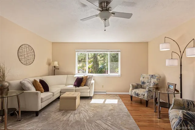 a living room with furniture and wooden floor