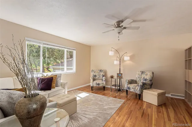 a living room with furniture a rug and a table