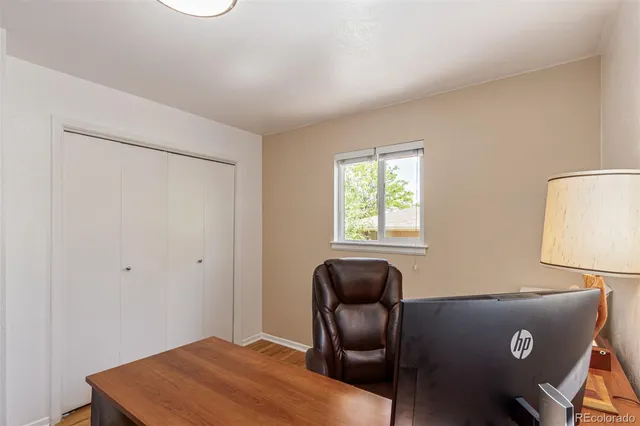 a view of a workspace with furniture and a window