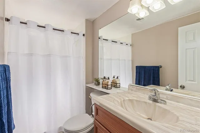 a bathroom with a sink a bath tub and a window