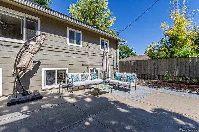 a view of patio with a table and chairs and potted plants