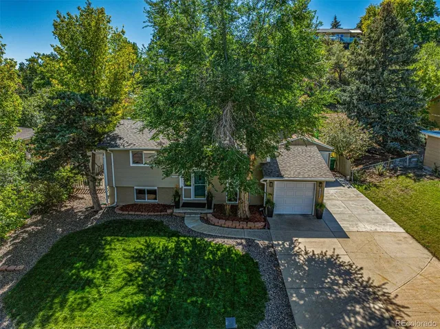an aerial view of a house with a yard and garden