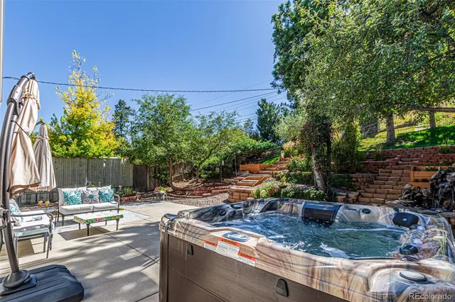a view of backyard with swimming pool and outdoor seating