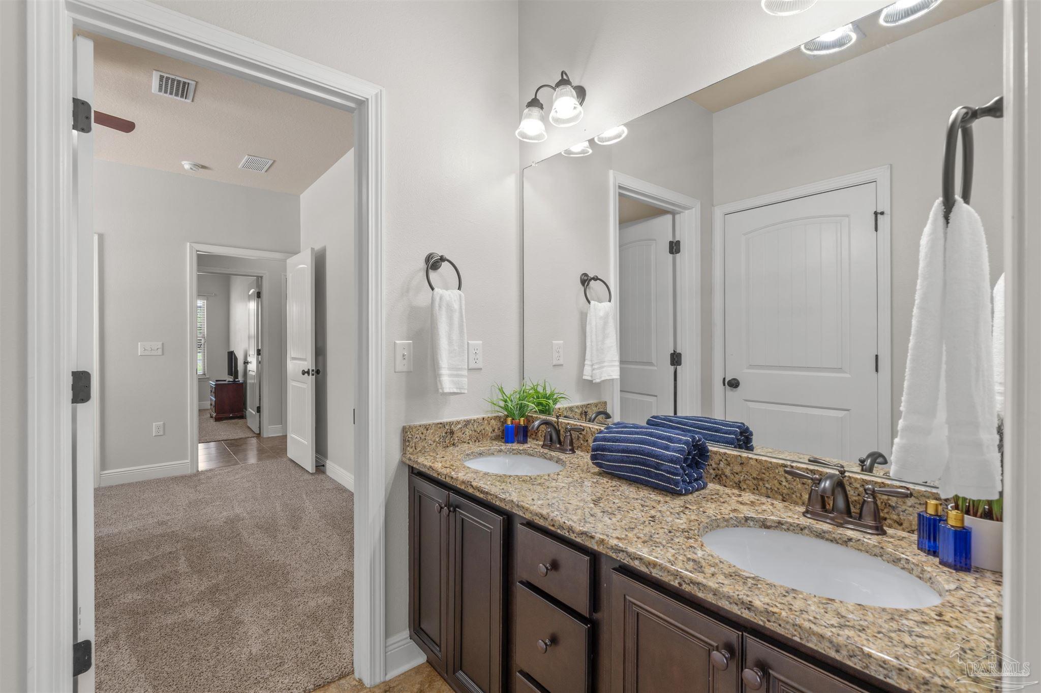 2698 Tulip Hill Road Pace, FL 32571 - Photo 28 of 65 a bathroom with a granite countertop sink and a mirror