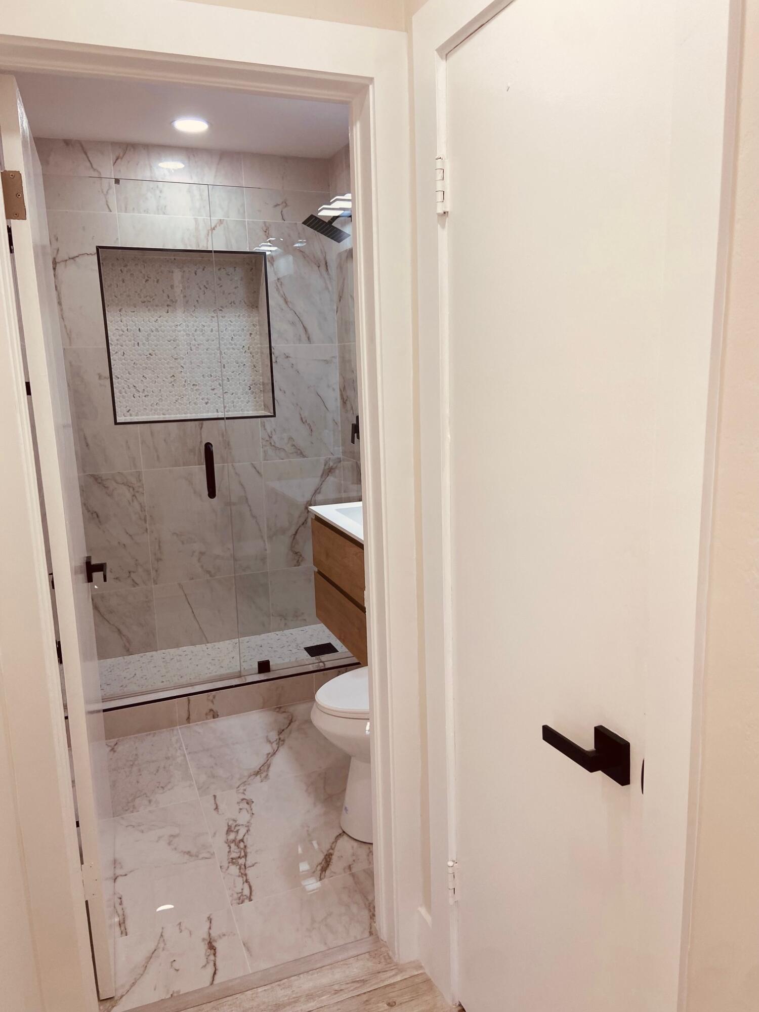 615 Northeast 2nd Avenue Delray Beach, FL 33444 - Photo 19 of 35 a bathroom with a toilet and a shower