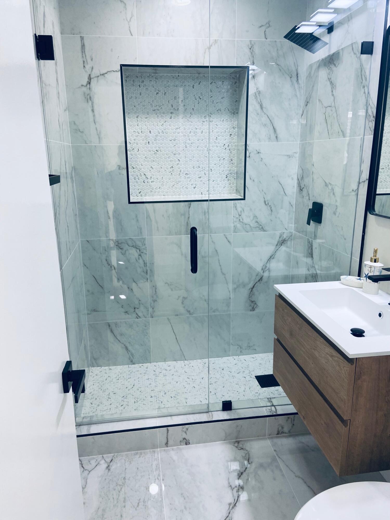 615 Northeast 2nd Avenue Delray Beach, FL 33444 - Photo 20 of 35 a bathroom with a sink a mirror and shower