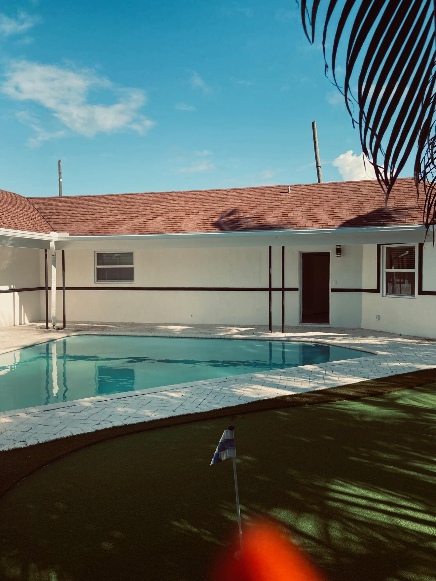 615 Northeast 2nd Avenue Delray Beach, FL 33444 - Photo 29 of 35 a backyard of a house with wooden floor and fence
