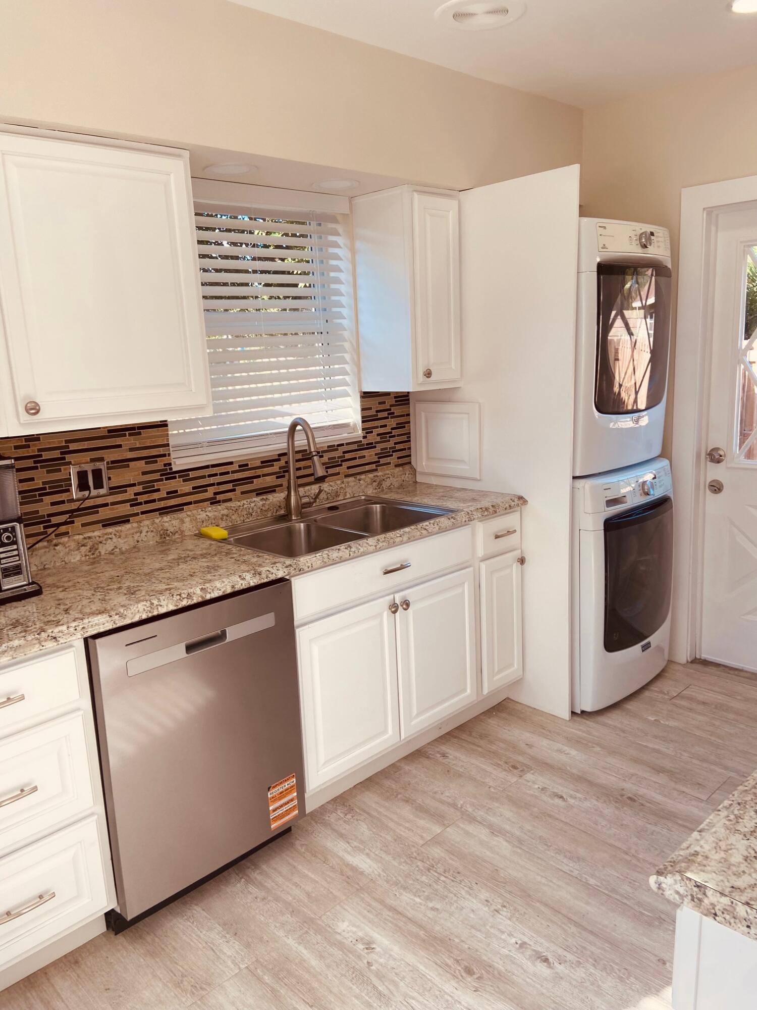 615 Northeast 2nd Avenue Delray Beach, FL 33444 - Photo 10 of 35 a kitchen with granite countertop white cabinets and white appliances