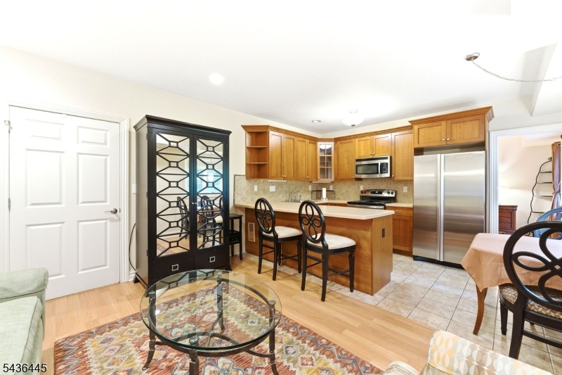4 Windemere Way Sparta, NJ 07871 - Photo 33 of 50 a living room with stainless steel appliances kitchen island granite countertop furniture and a rug