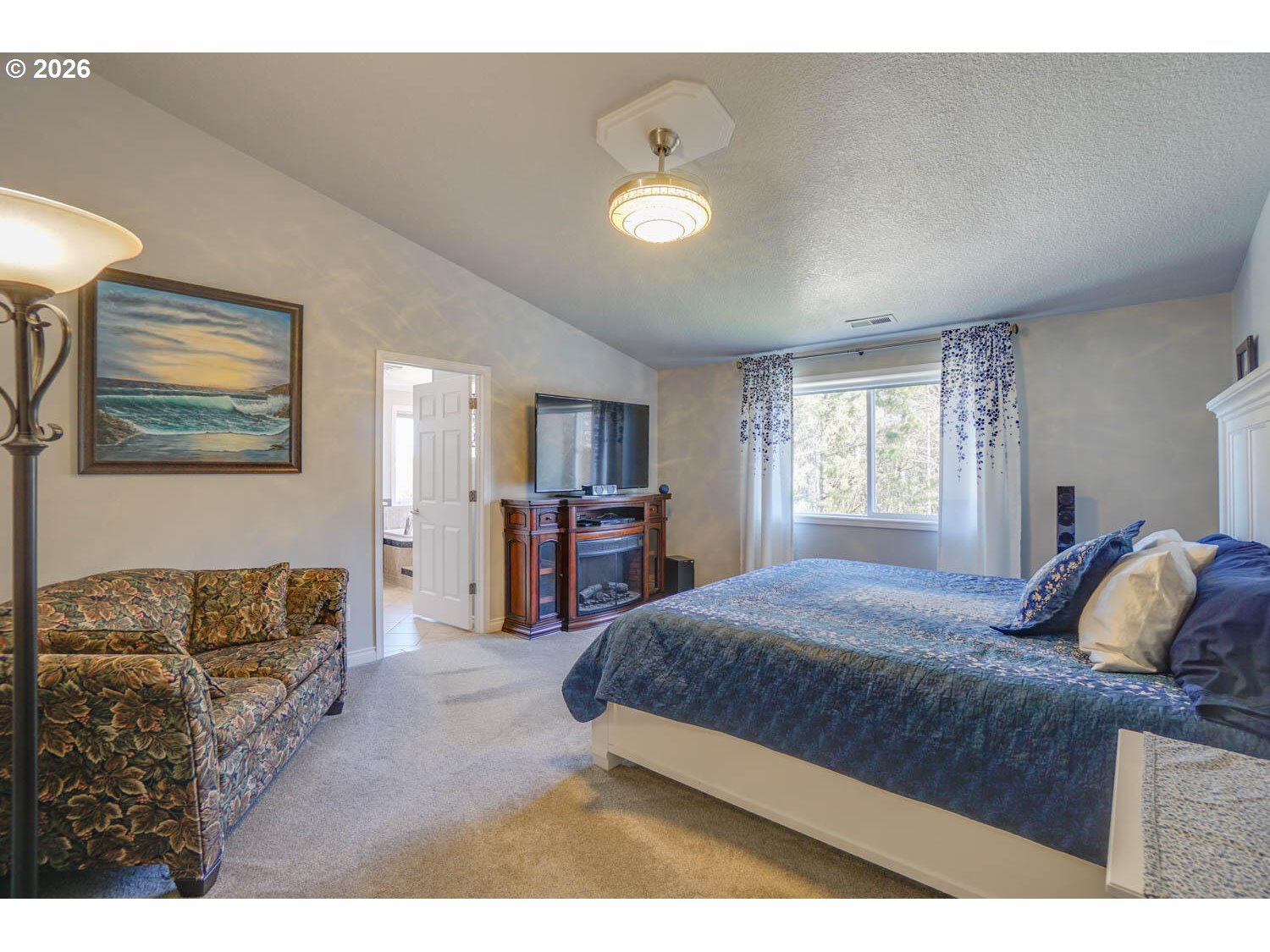 1612 North Heron Drive Ridgefield, WA 98642 - Photo 14 of 33 a bedroom with a large bed and a couch
