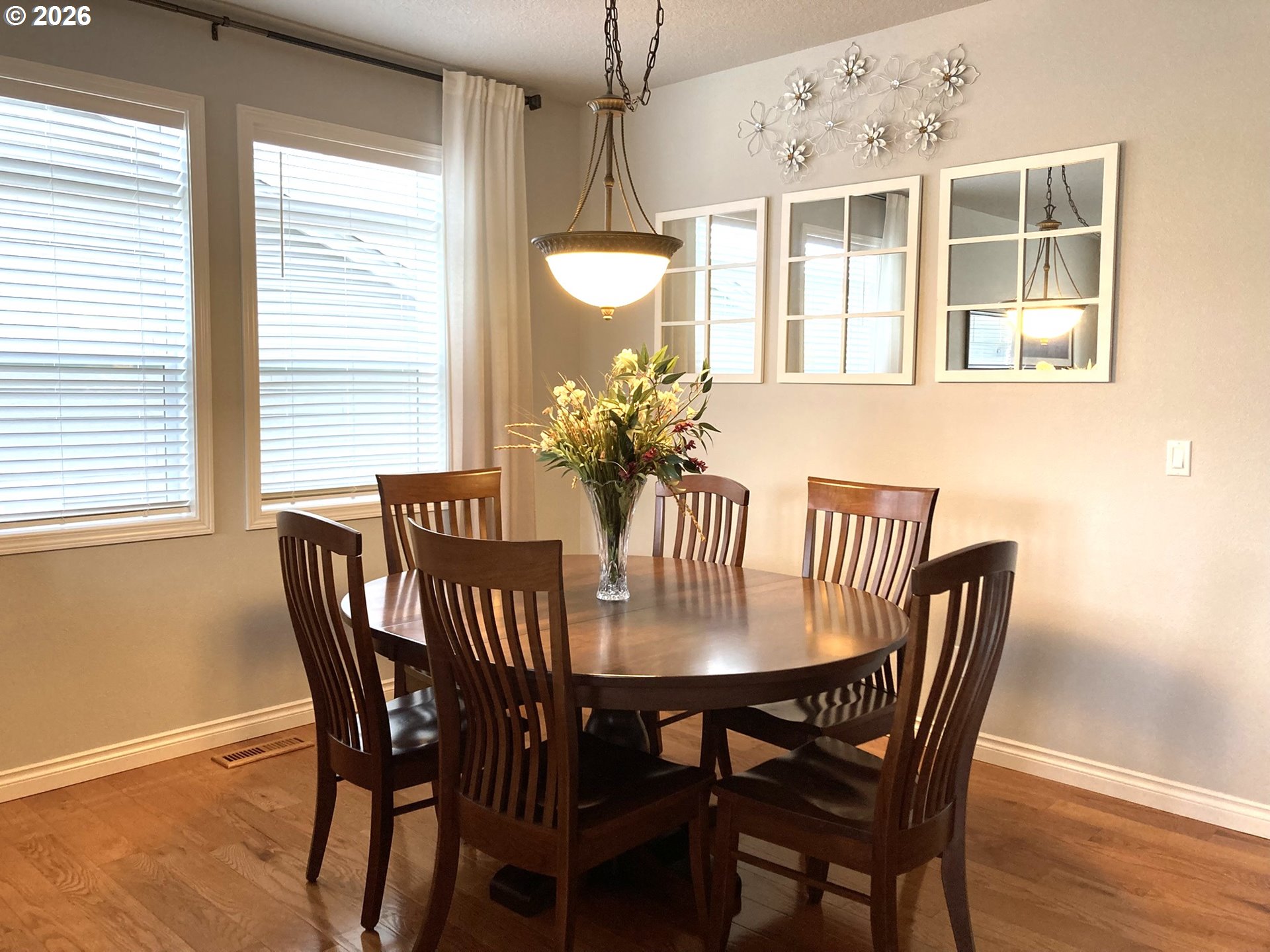 1612 North Heron Drive Ridgefield, WA 98642 - Photo 4 of 33 a dining room with furniture potted plants and wooden floor
