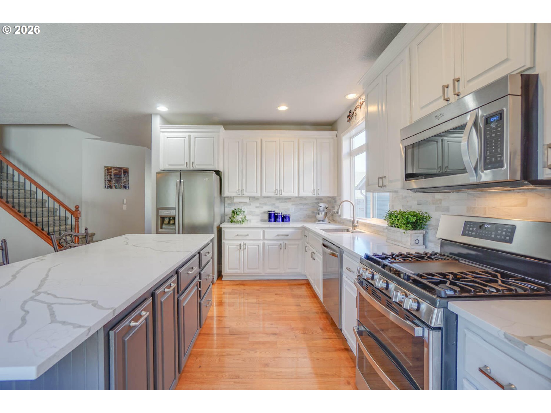 1612 North Heron Drive Ridgefield, WA 98642 - Photo 7 of 33 a kitchen with stainless steel appliances granite countertop a stove top oven a sink dishwasher and a refrigerator