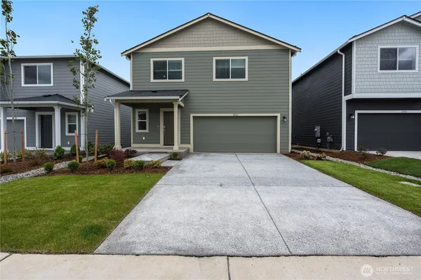 a front view of house with yard and green space