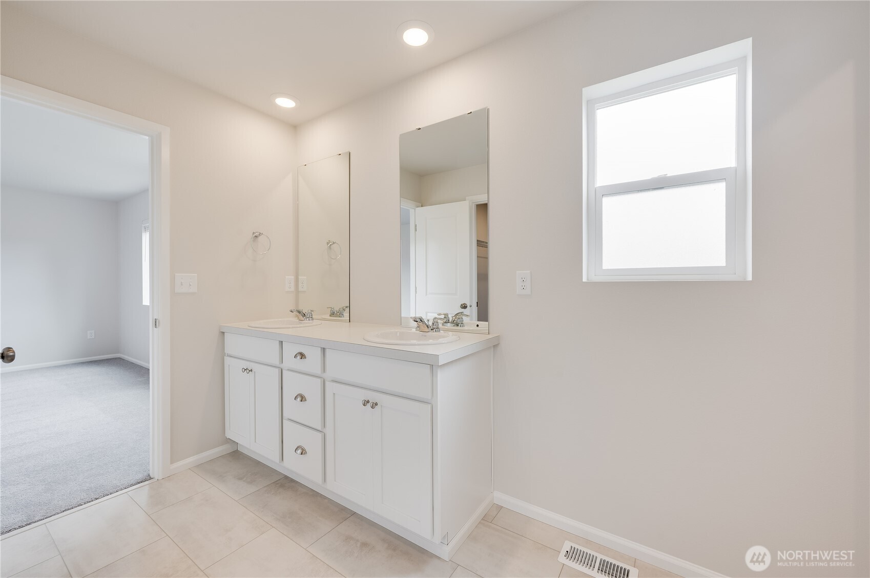 1012 15th Avenue Sultan, WA 98294 - Photo 14 of 26 a bathroom with a double vanity sink a mirror and a bathtub