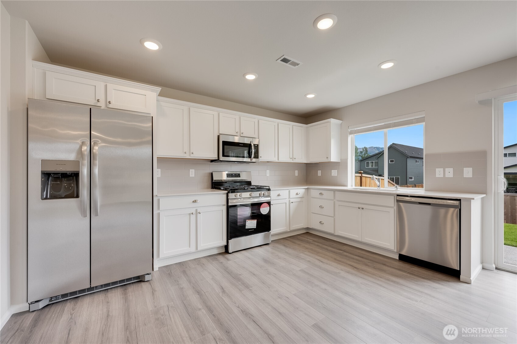 1012 15th Avenue Sultan, WA 98294 - Photo 4 of 26 a kitchen with granite countertop white cabinets and stainless steel appliances