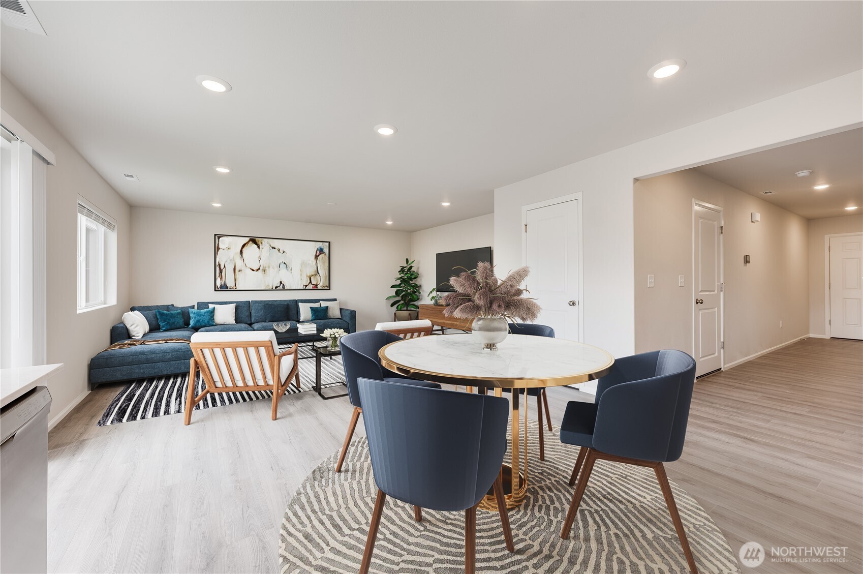1012 15th Avenue Sultan, WA 98294 - Photo 6 of 26 a living room with furniture and a dining table with wooden floor