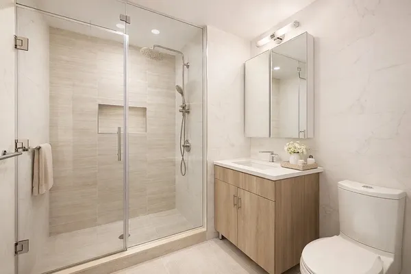 a bathroom with a sink a toilet and shower