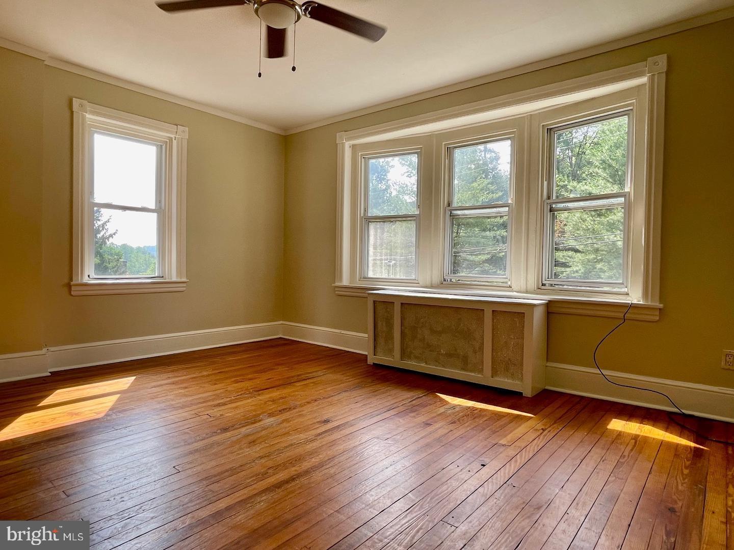 692 Lenni Road Aston, PA 19014 - Photo 16 of 28 a view of an empty room with wooden floor and a window