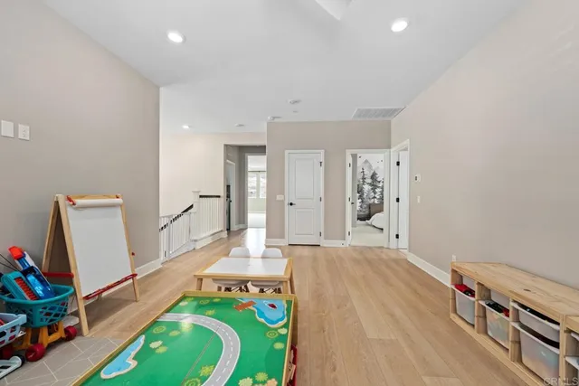a bedroom with furniture and a wooden floor