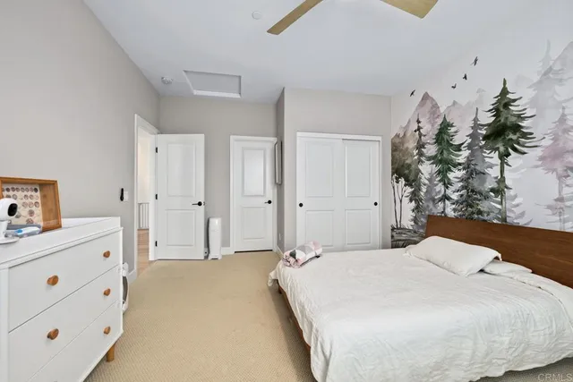 a spacious bedroom with a bed and a potted plant