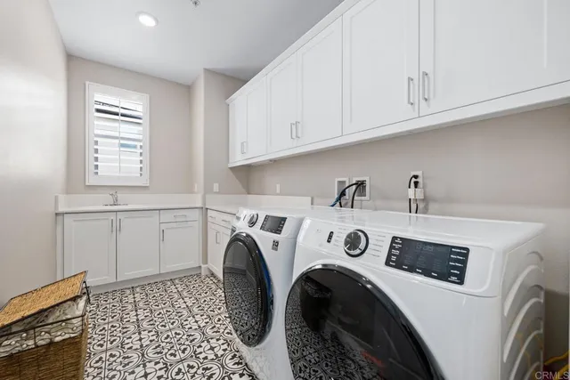 a utility room with sink dryer and washer