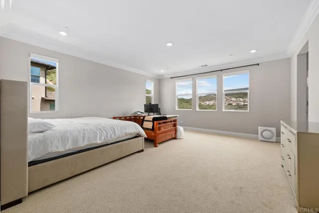 a bedroom with a bed and a large window