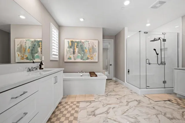 a bathroom with a sink mirror and a bath tub
