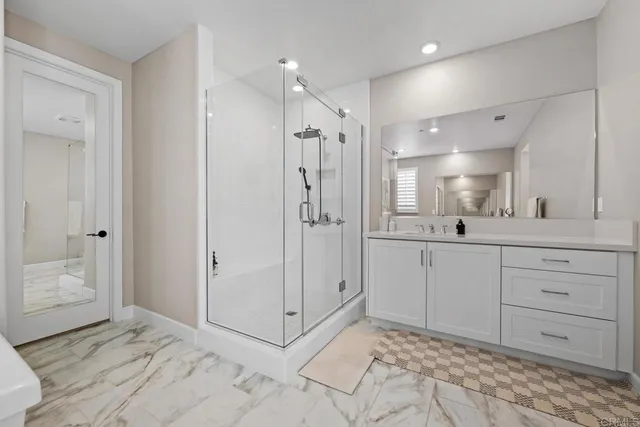 a bathroom with a shower sink and mirror