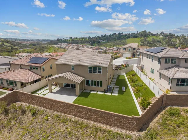 an aerial view of a house with a big yard