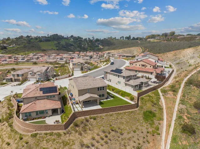 an aerial view of a house with outdoor space and lake view