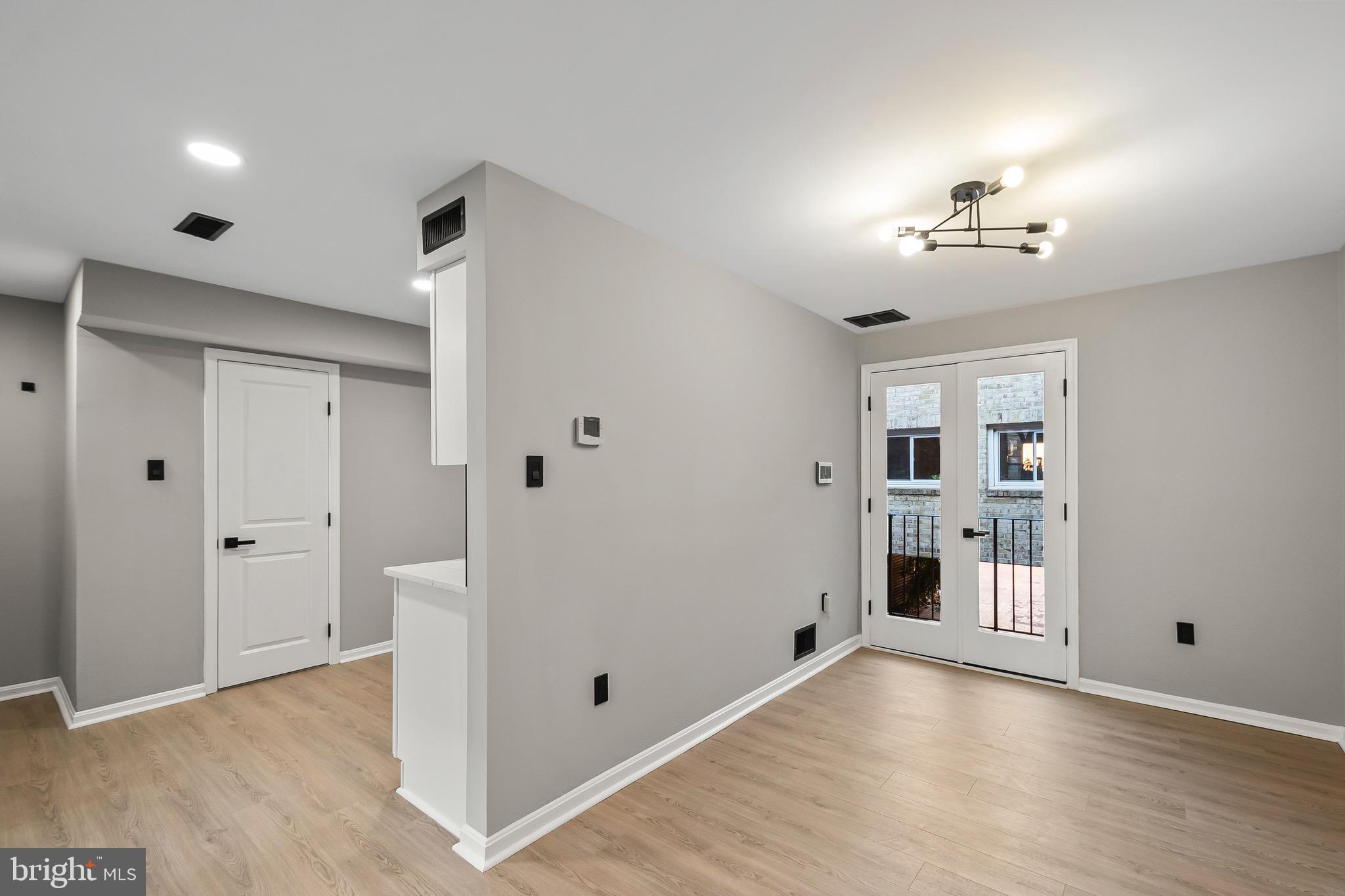 1527 North Colonial Terrace, Unit B Arlington, VA 22209 - Photo 11 of 28 wooden floor in an empty room with a window