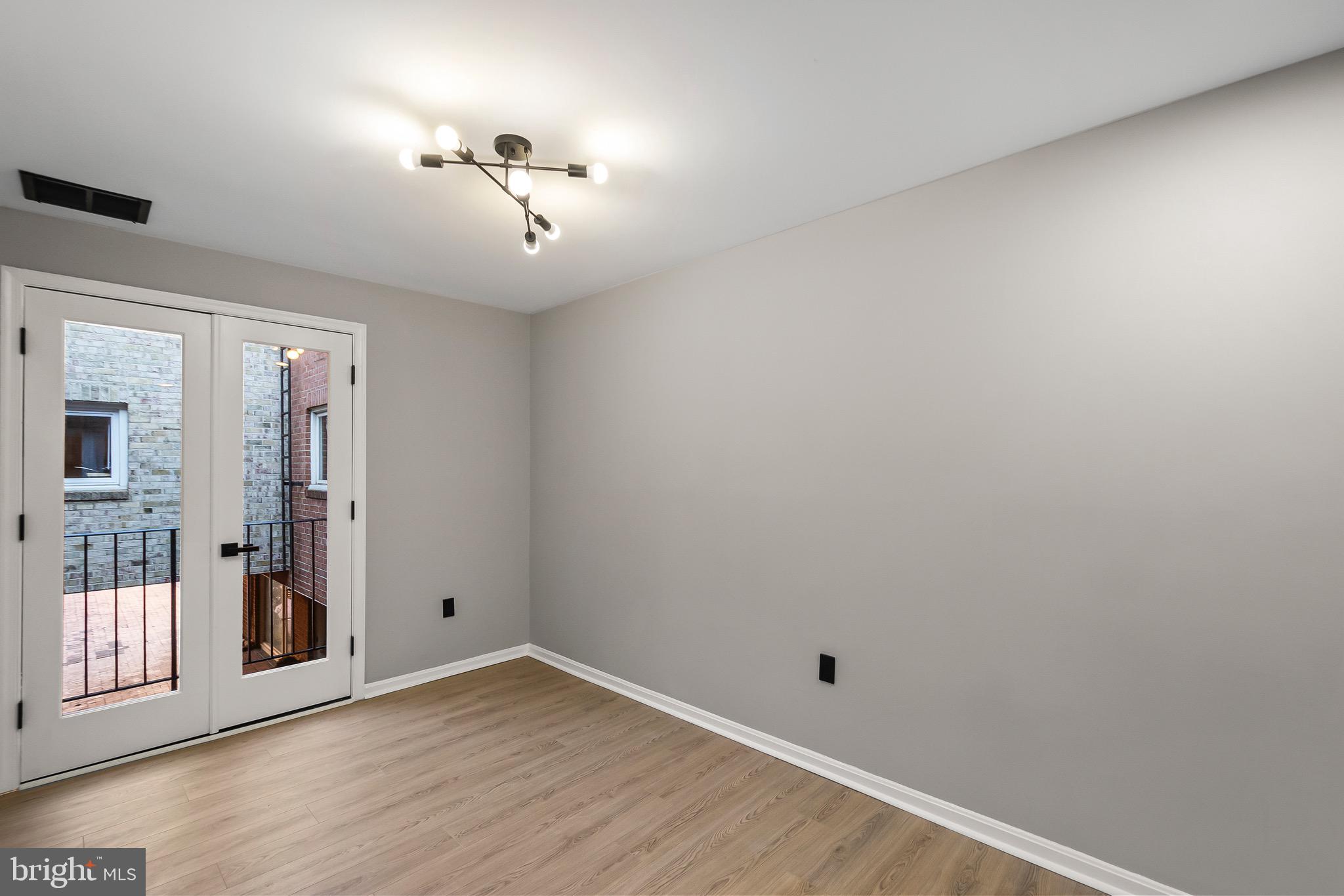 1527 North Colonial Terrace, Unit B Arlington, VA 22209 - Photo 12 of 28 wooden floor in an empty room with a window