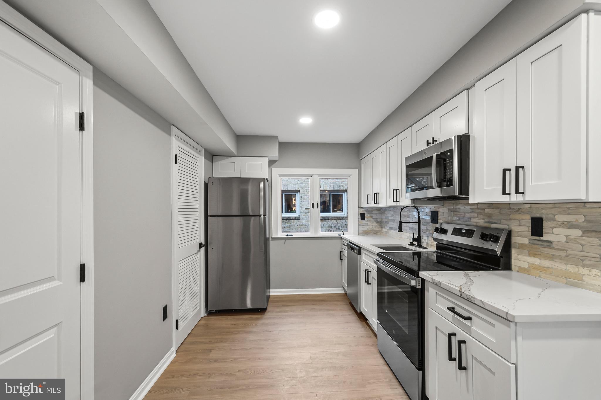 1527 North Colonial Terrace, Unit B Arlington, VA 22209 - Photo 15 of 28 a kitchen with stainless steel appliances granite countertop a refrigerator a stove top oven a sink and dishwasher