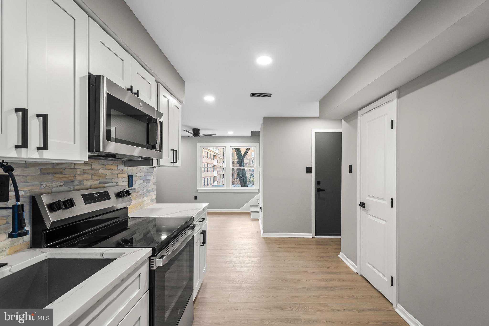 1527 North Colonial Terrace, Unit B Arlington, VA 22209 - Photo 16 of 28 a kitchen with stainless steel appliances a stove a sink and a microwave