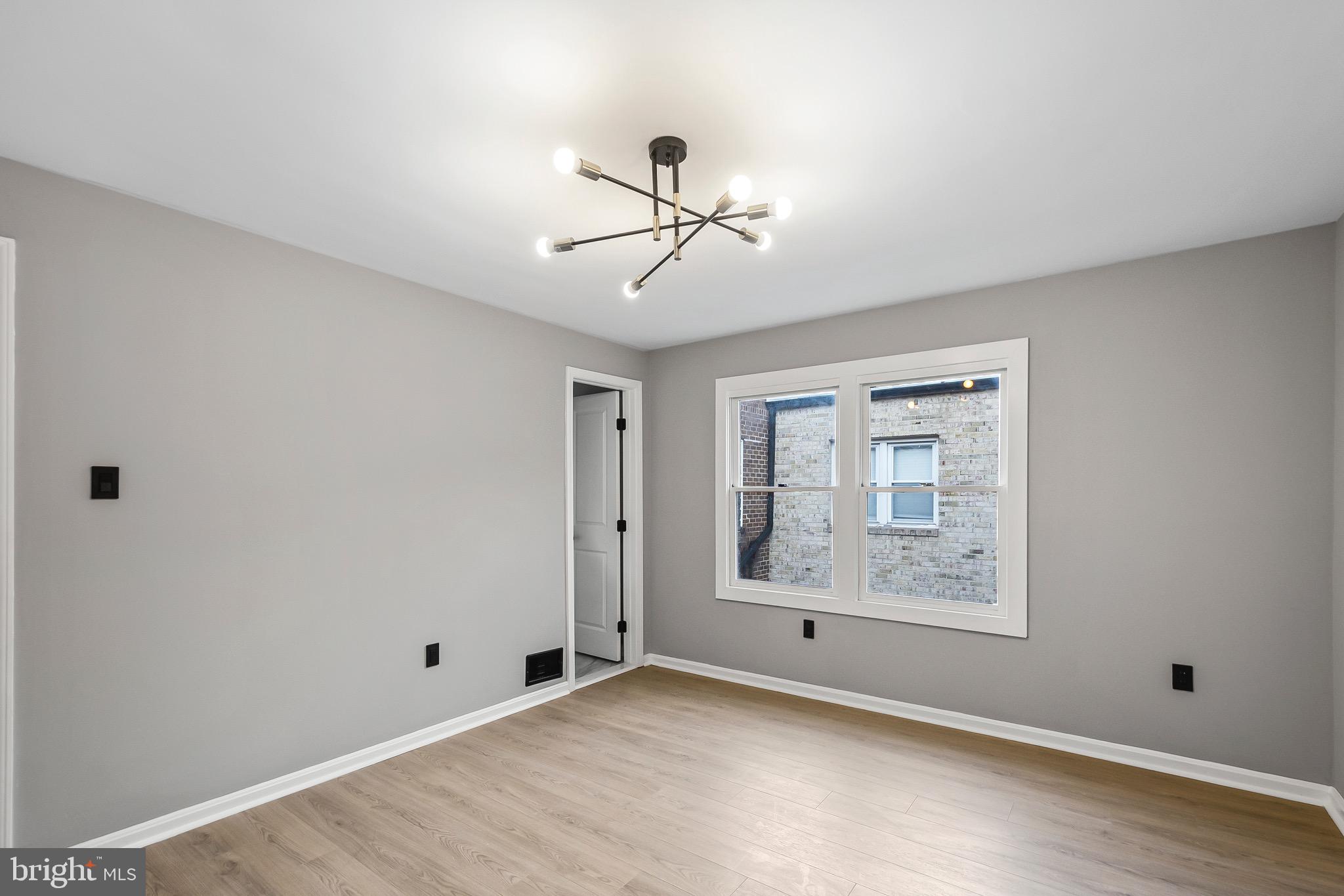 1527 North Colonial Terrace, Unit B Arlington, VA 22209 - Photo 19 of 28 a view of a room with a chandelier fan and windows