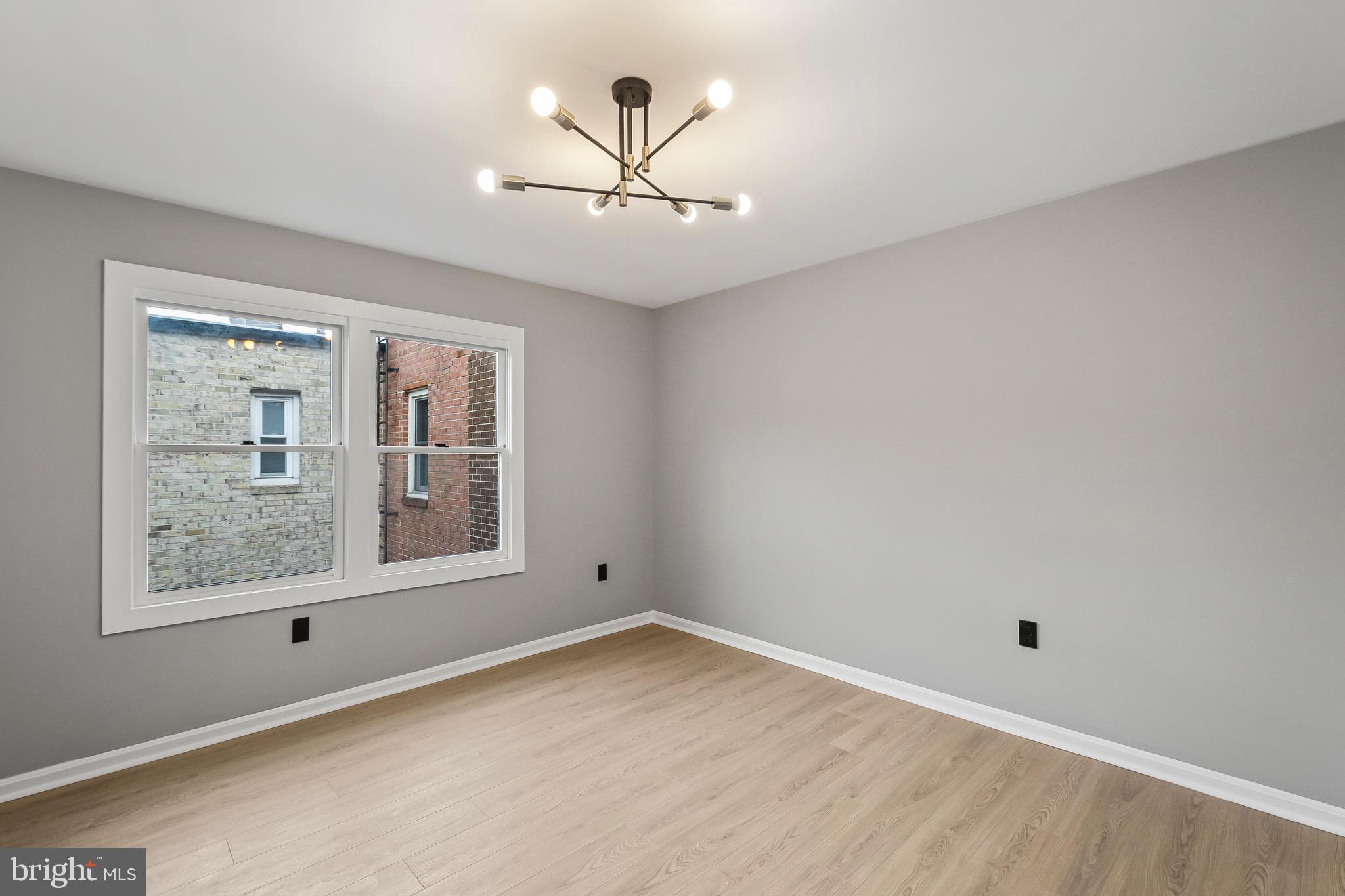 1527 North Colonial Terrace, Unit B Arlington, VA 22209 - Photo 20 of 28 an empty room with windows and fan