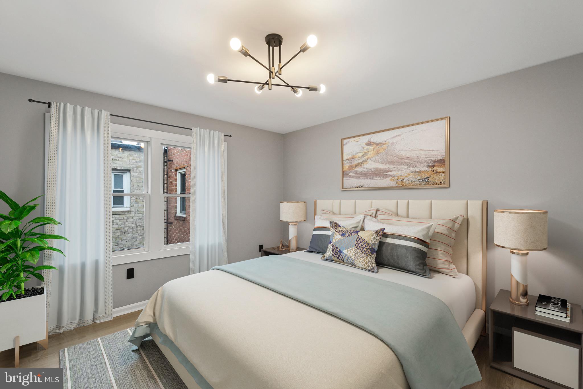 1527 North Colonial Terrace, Unit B Arlington, VA 22209 - Photo 21 of 28 a bedroom with a large bed and a chandelier