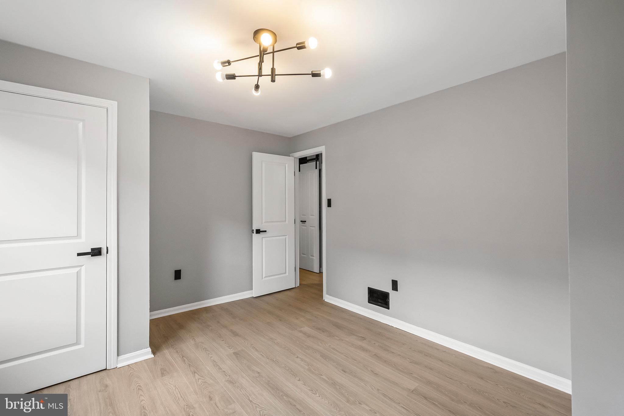 1527 North Colonial Terrace, Unit B Arlington, VA 22209 - Photo 24 of 28 an empty room with wooden floor and ceiling fan
