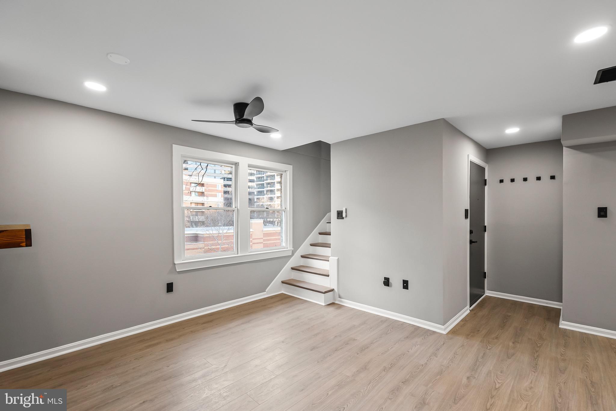 1527 North Colonial Terrace, Unit B Arlington, VA 22209 - Photo 5 of 28 a view of an empty room with wooden floor and a window