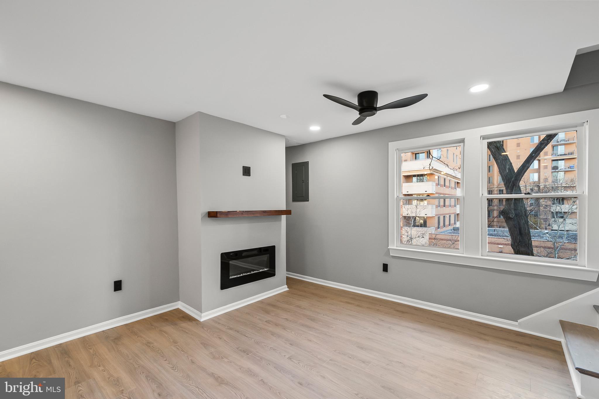 1527 North Colonial Terrace, Unit B Arlington, VA 22209 - Photo 6 of 28 a view of an empty room with a fireplace and a window