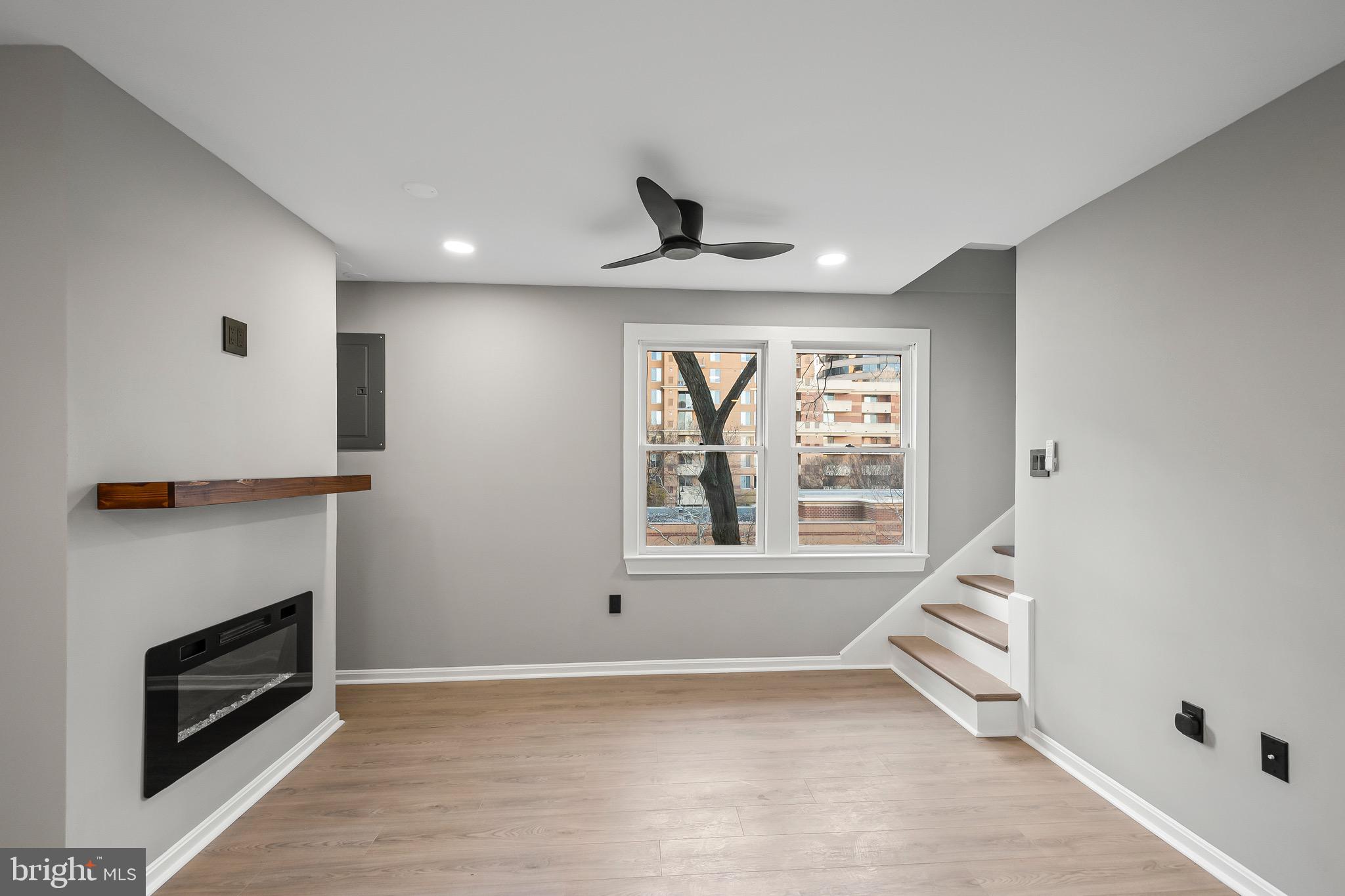 1527 North Colonial Terrace, Unit B Arlington, VA 22209 - Photo 7 of 28 a view of an empty room with a fireplace and a window