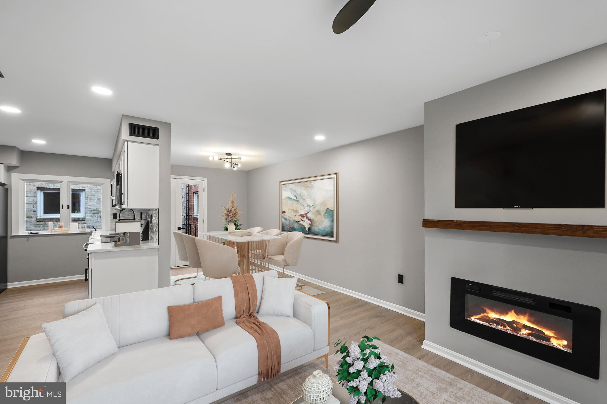 1527 North Colonial Terrace, Unit B Arlington, VA 22209 - Photo 10 of 28 a living room with furniture a flat screen tv and a fireplace