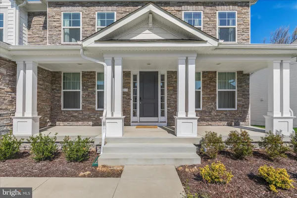 a room with furniture a chandelier and a fireplace