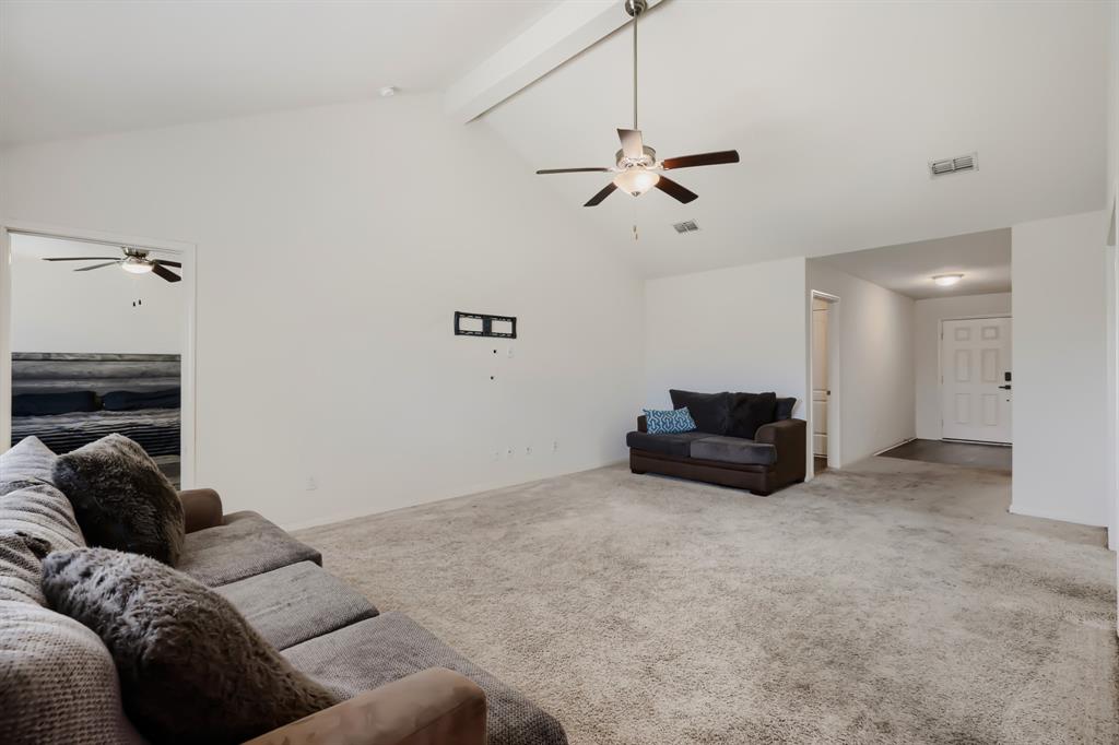 4309 Cat Tail Way Forney, TX 75126 - Photo 7 of 30 Spacious living area featuring vaulted ceilings, light-colored carpeting, and a ceiling fan