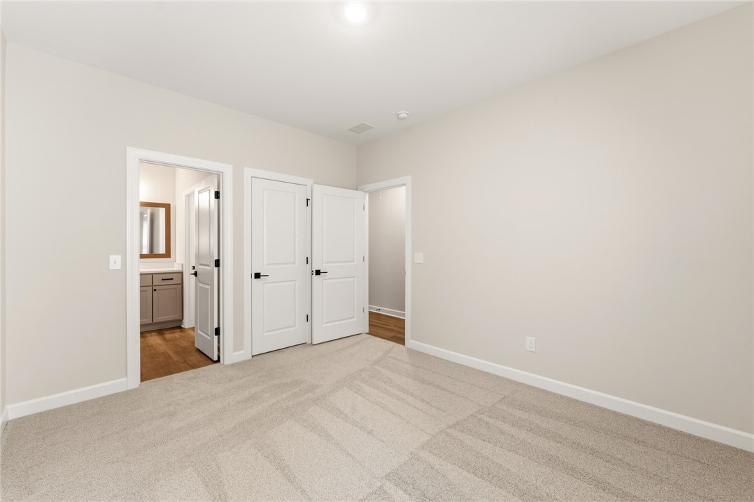 701 Weathered Oak Way Anderson, SC 29621 - Photo 33 of 41 This carpeted room offers versatile living options, featuring ample space and clear connections to other rooms.
