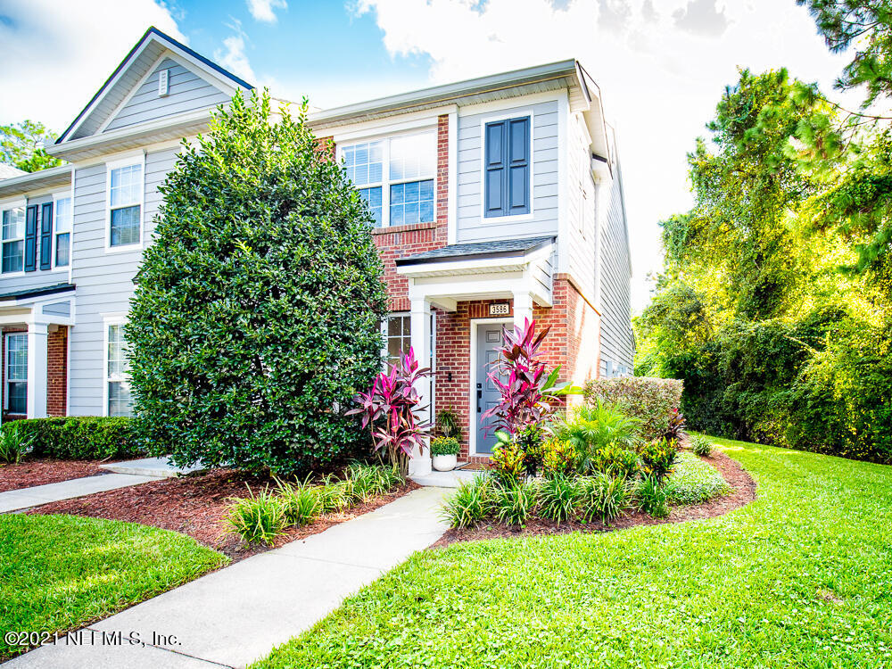3586 Pebble Path Lane Jacksonville, FL 32224 - Photo 1 of 21 a front view of house and yard with beautiful flowers and green space