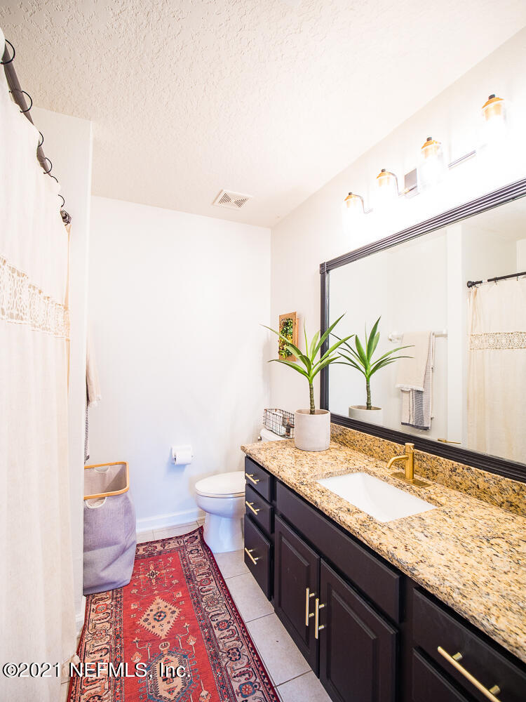 3586 Pebble Path Lane Jacksonville, FL 32224 - Photo 14 of 21 a bathroom with a granite countertop sink and a mirror